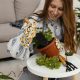 smiley-woman-home-with-pot-plant-gardening-tools